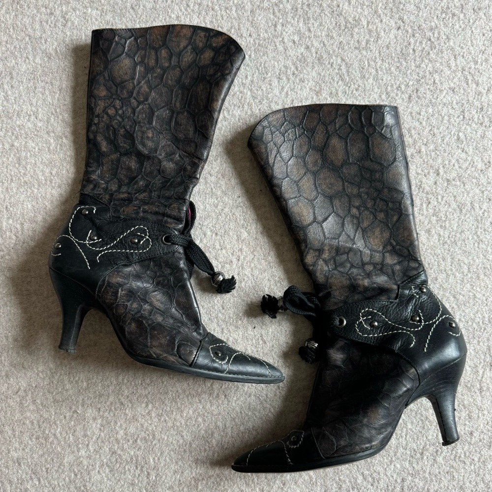 Black and brown leather kitten heeled boots with bow detailing on the front